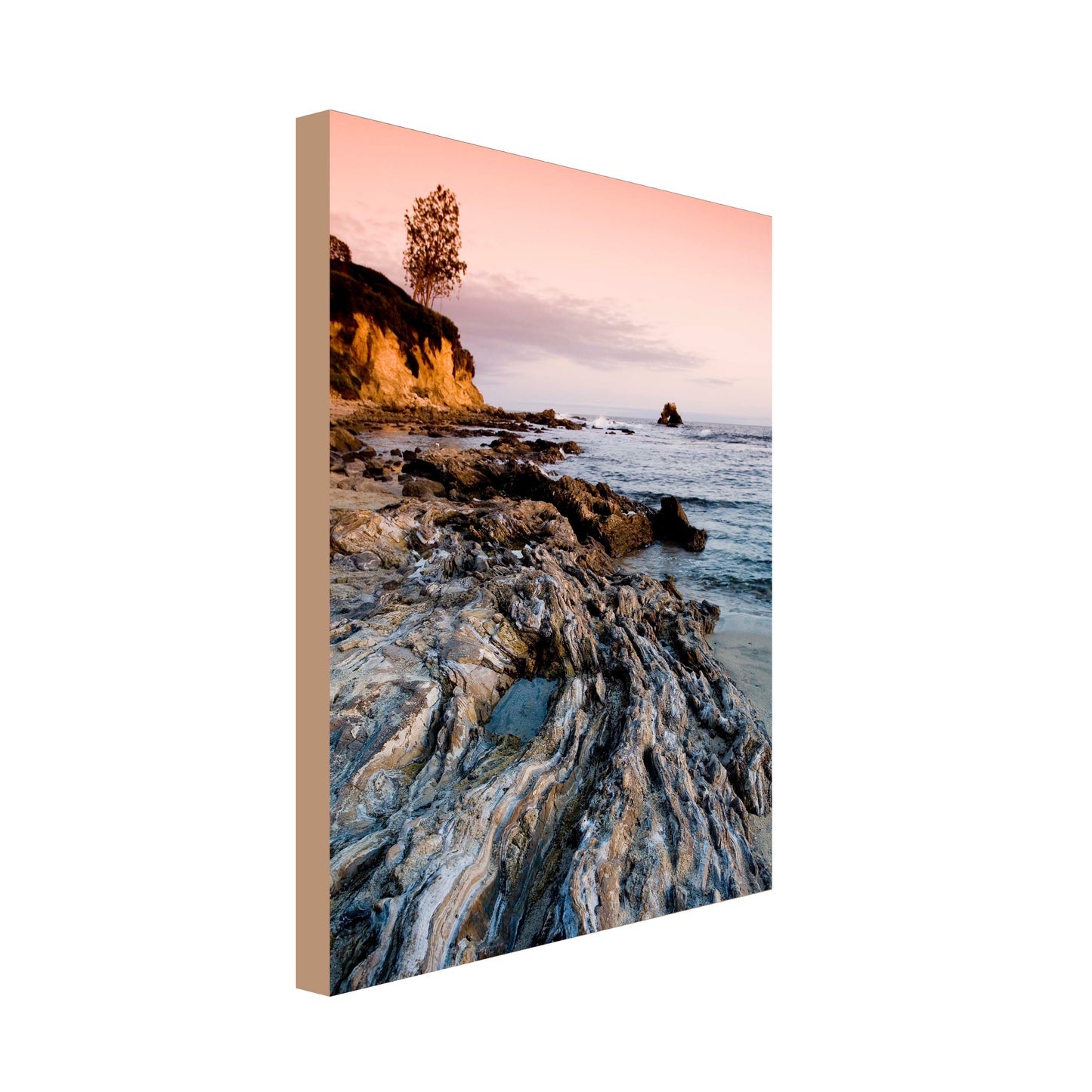 Portrait image of sunset over rock pools at sea with steep cliffs to the peripheral of the image