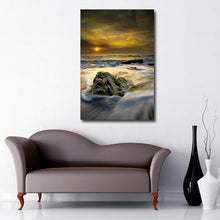 Load image into Gallery viewer, Portrait Art Canvas of cloudy sunset over rough seas with rock in the foreground 
